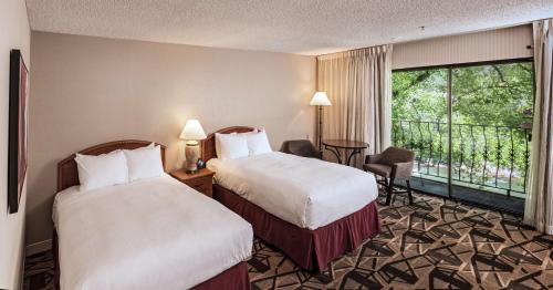 a hotel room with two beds and a balcony at DoubleTree by Hilton Durango in Durango