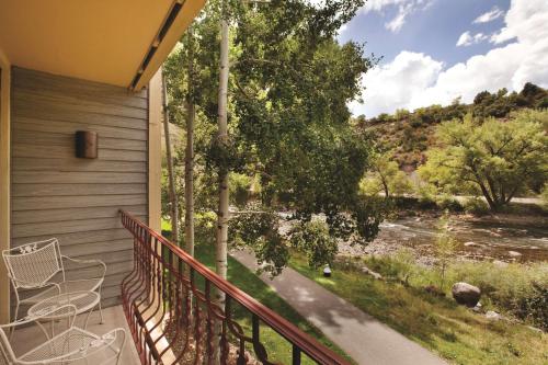 a balcony with chairs and a view of a river at DoubleTree by Hilton Durango in Durango