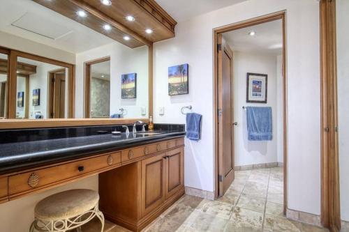 a bathroom with a sink and a large mirror at Oceanfront Penthouse, 2 Masters, 2 Baths, kitchen! in Cabo San Lucas