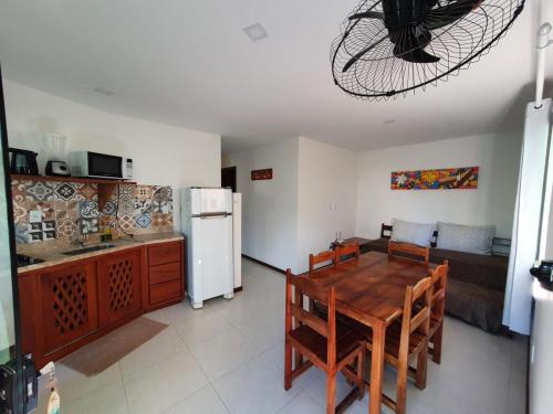 uma cozinha e sala de jantar com uma mesa e um frigorífico em kosomao 2 em Morro de São Paulo
