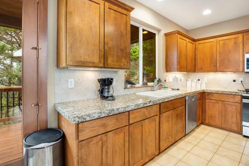 a kitchen with wooden cabinets and a counter top at Vista Azul in Oceanside