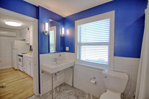 a bathroom with a sink and a toilet and blue walls at Gulside Resort. Unit 8 in St. Pete Beach