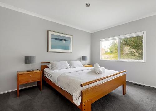 a bedroom with a large bed and a window at Pool Haven on Leah in Rye