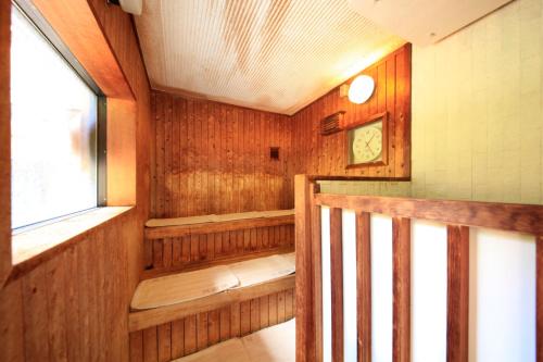 a room with a sauna with a window at 湯元ホテル阿智川 in Komaba