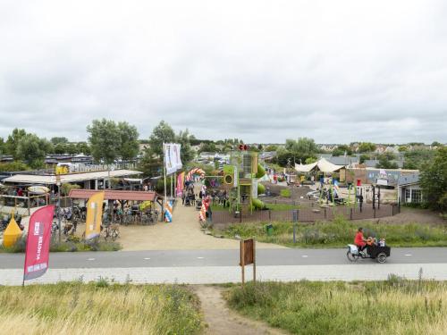 an amusement park with a roller coaster and rides at Bungalow in 's-Gravenzande with Nautical Charm in 's-Gravenzande