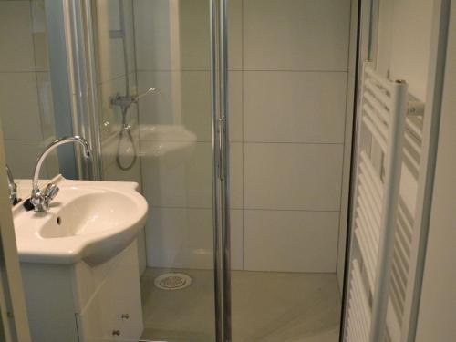 a bathroom with a shower and a sink at Bungalow in Netherlands with Ship-Like Design in 's-Gravenzande