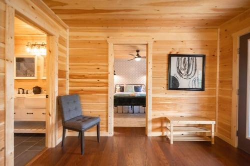 a wooden room with a chair and a table at Family Cabin Near Smoky Mtn Entrance Nantahala in Robbinsville