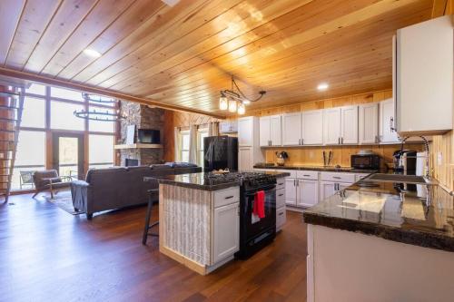 a kitchen with white cabinets and wooden floors and a counter top at Family Cabin Near Smoky Mtn Entrance Nantahala in Robbinsville