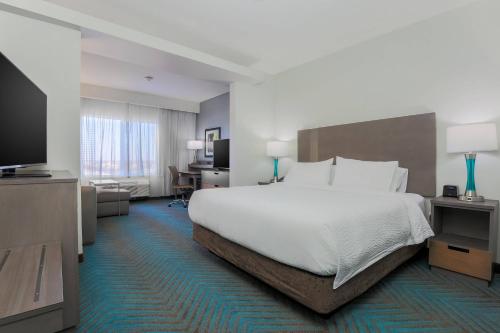 a hotel room with a bed and a flat screen tv at Fairfield Inn & Suites by Marriott Wichita Falls Northwest in Wichita Falls