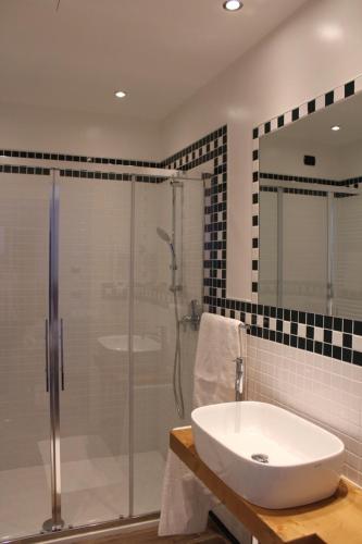 a bathroom with a sink and a glass shower at Locanda Ai Due Orsi in Milan