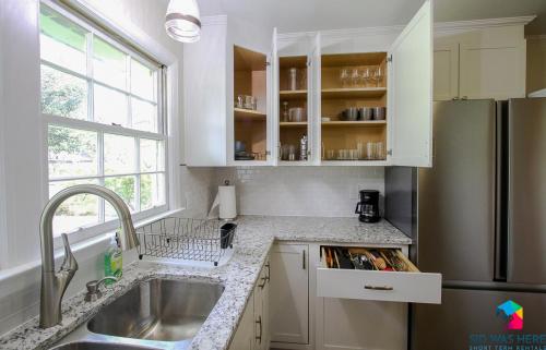a kitchen with a sink and a refrigerator at Savannah Home In Northwood in Savannah