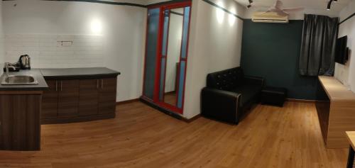 a kitchen with a sink and a chair in a room at Smile Hotel C180 Cheras Selatan in Cheras