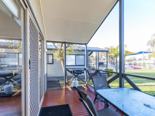 an open patio with a table and chairs on a deck at NRMA Yarrawonga Mulwala Holiday Park in Mulwala