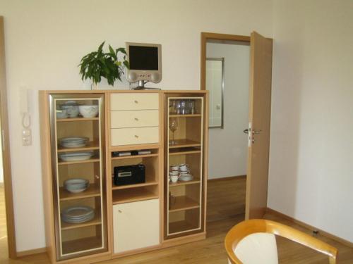 a living room with a tv and a dresser with a tvicterictericter at Ferienwohnung Mautweg in Bad Reichenhall