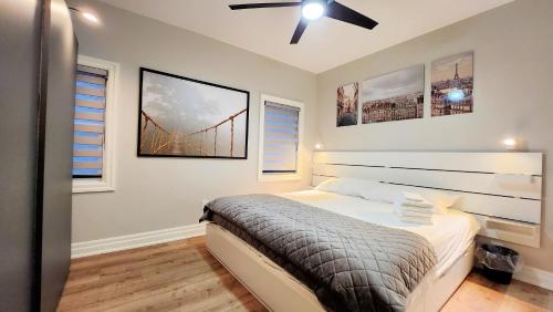 a bedroom with a bed and two pictures on the wall at The Cozy Cove Modern King-Bedroom Full Apartment in St. Catharines