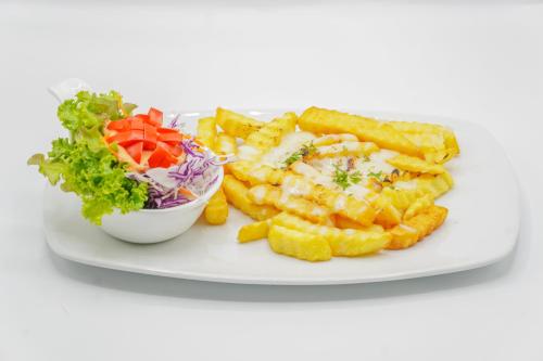 a plate of food with french fries and a salad at Combo Beach Hotel Samui in Chaweng