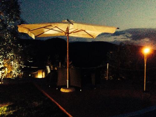 a white umbrella sitting on top of a hill at night at I Giardini Di Margius in Itri