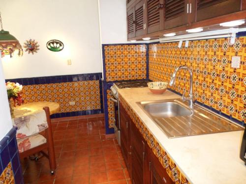 a kitchen with a sink and a counter at Humble, Right On The Beach in Akumal