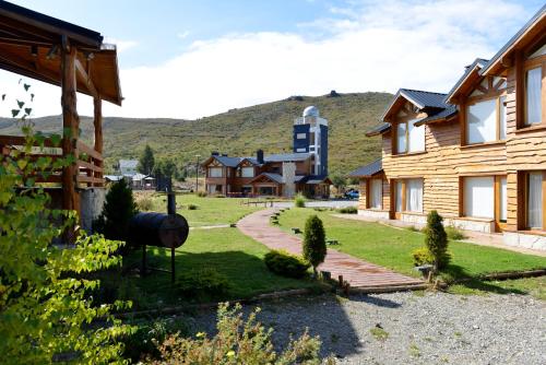 a view of the yard of a log house at Galileo Boutique Hotel in San Carlos de Bariloche