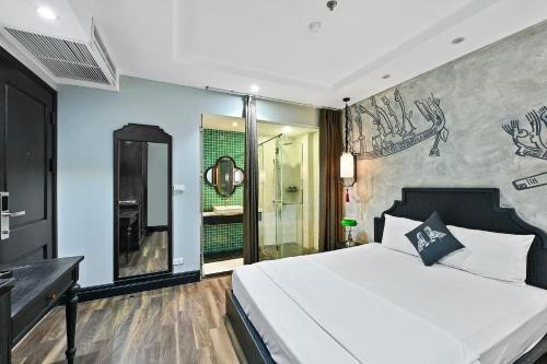 a bedroom with a large bed and a shower at 22Land Residence Hotel & Spa 52 Ngo Huyen in Hanoi