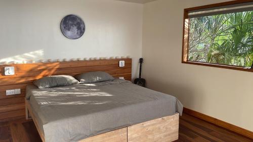 a bedroom with a large bed with a window at Tantawan sea view residence 山海居 in Salad Beach