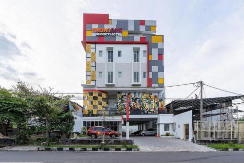 a tall building with a building with a sign on it at Front One The Andia Boyolali in Boyolali