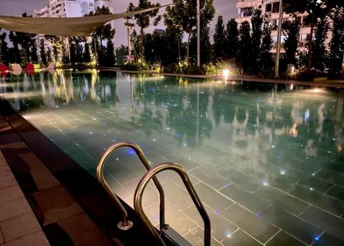 a swimming pool at night with a stairway in it at Opus Residence KL by EUcation Home in Kuala Lumpur