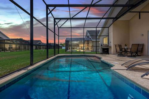 a swimming pool in the middle of a house at Disney Area 4BR Home with Heated Private Pool in Kissimmee