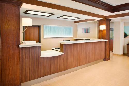 a hospital room with a waiting area and a mirror at Fairfield Inn & Suites by Marriott Lafayette South in Lafayette