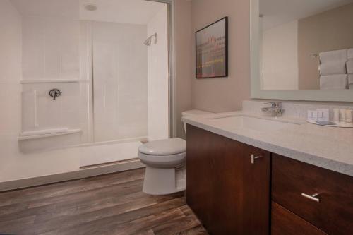 a bathroom with a toilet and a sink and a shower at TownePlace Suites by Marriott Altoona in Altoona