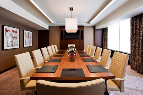 a conference room with a long wooden table and chairs at The Westin Birmingham in Birmingham