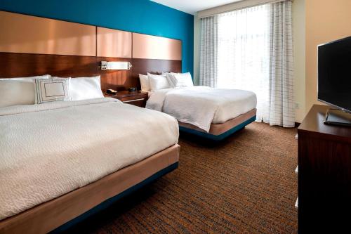 a hotel room with two beds and a flat screen tv at Residence Inn by Marriott Fishkill in Fishkill