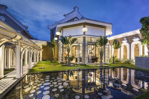 a mansion with a pool in front of it at JW Marriott Phu Quoc Emerald Bay Resort & Spa in Phú Quốc