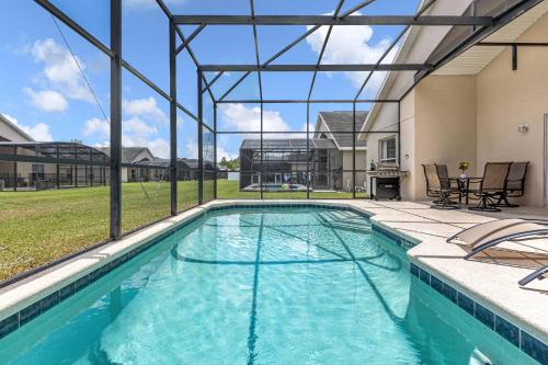 a swimming pool with a view of a house at Disney Area 4BR Home with Heated Private Pool in Kissimmee