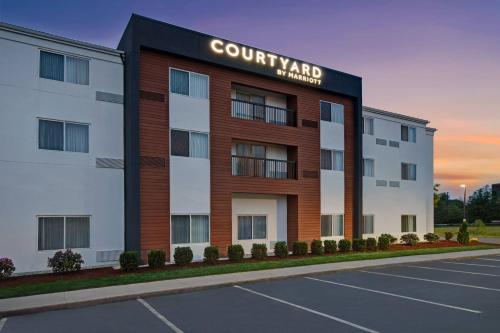 a rendering of a building with a court yard pharmacy at Courtyard Boston Raynham in Raynham