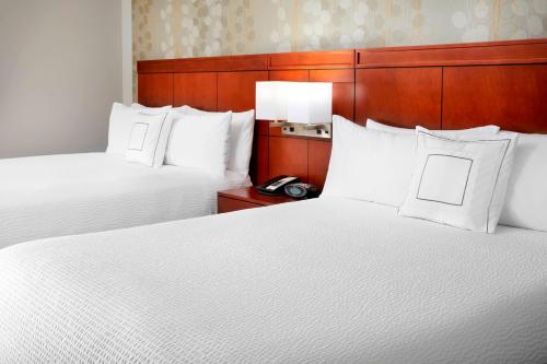 Habitación de hotel con 2 camas y almohadas blancas en Courtyard Pittsburgh Settlers Ridge/Robinson Township, en Robinson Township