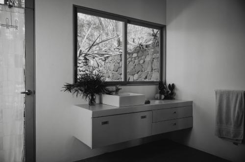 a bathroom with a sink and a window at Anzan Atitlan in San Marcos La Laguna