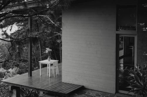 a small table with a vase on it on a porch at Anzan Atitlan in San Marcos La Laguna
