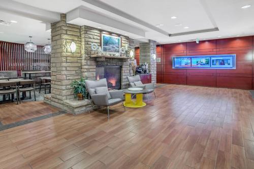 a lobby with a fireplace and a table and chairs at SpringHill Suites Pigeon Forge in Pigeon Forge