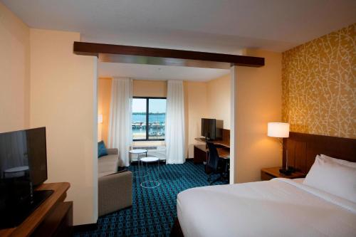 a hotel room with a bed and a desk and a television at Fairfield Inn & Suites by Marriott Detroit Lakes in Detroit Lakes