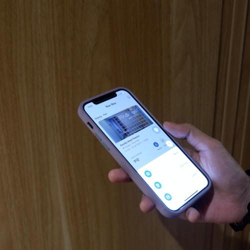 a person holding a cell phone in their hand at PassGo Thamrin in Jakarta