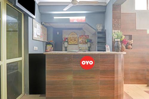 a counter in a room with a red approve sign on it at OYO Flagship Hotel Four Square in Lucknow