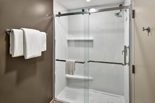 a shower with a glass door in a bathroom at Courtyard Philadelphia/Langhorne in Langhorne