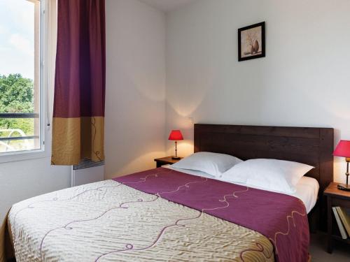 a bedroom with a large bed with a purple blanket at Beautiful apartment in a picturesque city in the Dordogne in Bergerac