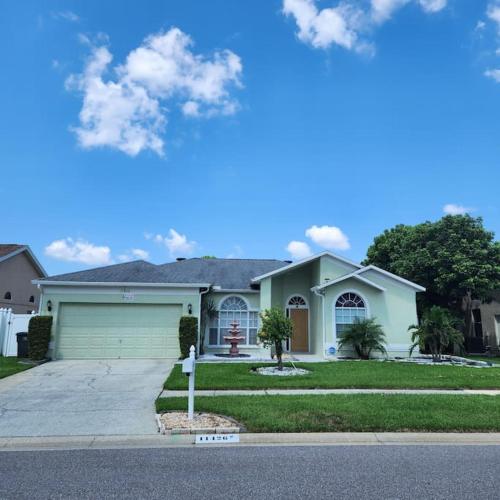 a house with a parking meter in front of it at Charming Vacation House 3Be 2Ba Solar heated pool in Tampa