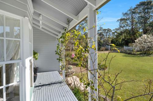 a white pergola on a house with a yard at Hygge House in Kangaroo Valley