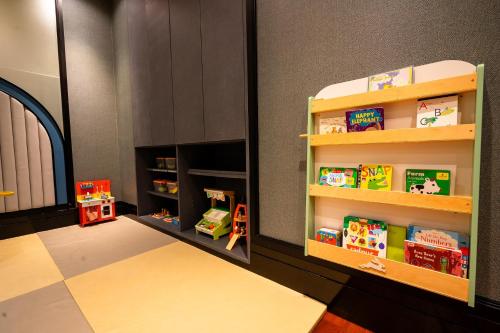 a childs play room with toys on shelves at Grande Centre Point Sukhumvit 55 Thong Lo in Bangkok