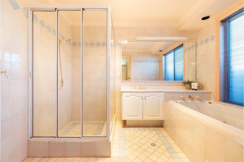 bagno con doccia, vasca e lavandino di White Sands, 14 Whitesands Road - Pet Friendly & Air Con a Fingal Bay