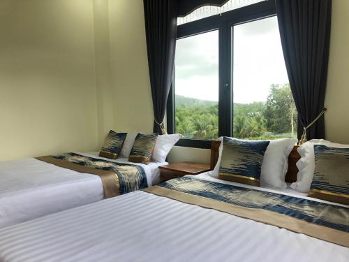 Postel nebo postele na pokoji v ubytování Hoàng Đô Hotel