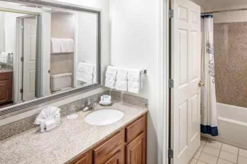 a bathroom with a sink and a mirror at Residence Inn Kansas City Country Club Plaza in Kansas City